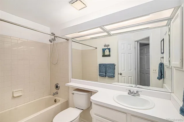 a bathroom with a sink toilet tub and shower