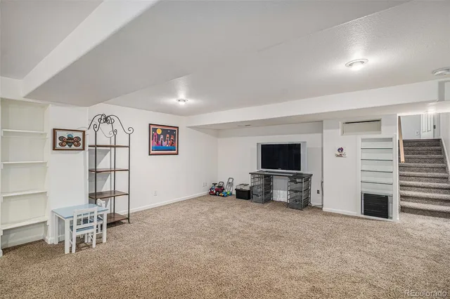 a view of a livingroom with furniture and a flat screen tv