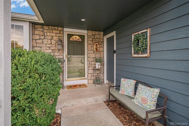 a view of front door of house with outdoor seating