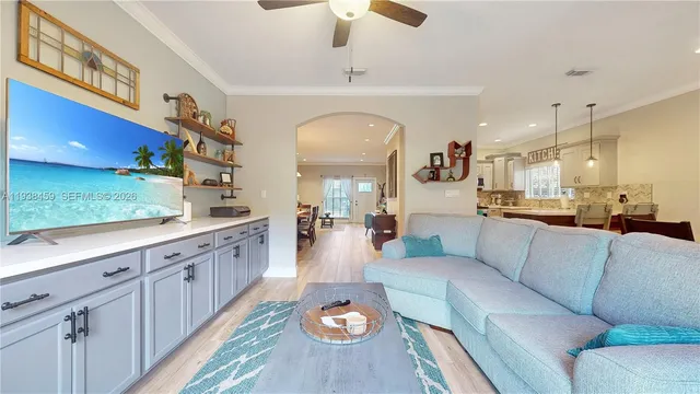 a living room with furniture and a chandelier