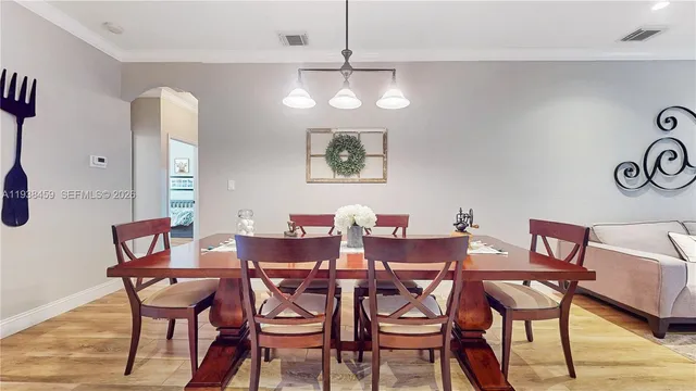 a view of a dining room with furniture and wooden floor