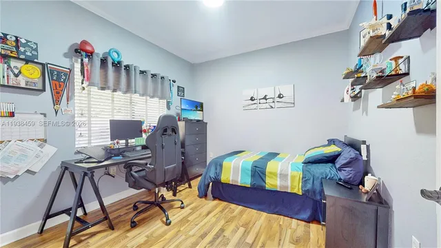 a bedroom with a bed and a desk