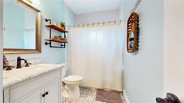 a bathroom with a toilet sink and mirror