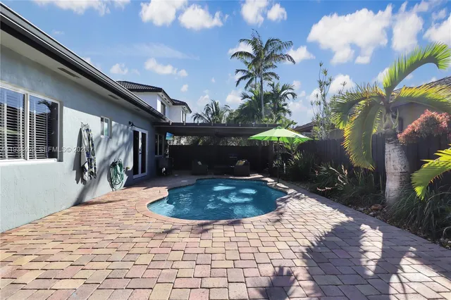 a outdoor living space with furniture potted plant and a large window