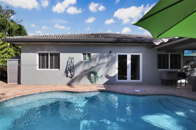 a front view of a house with a yard and trees