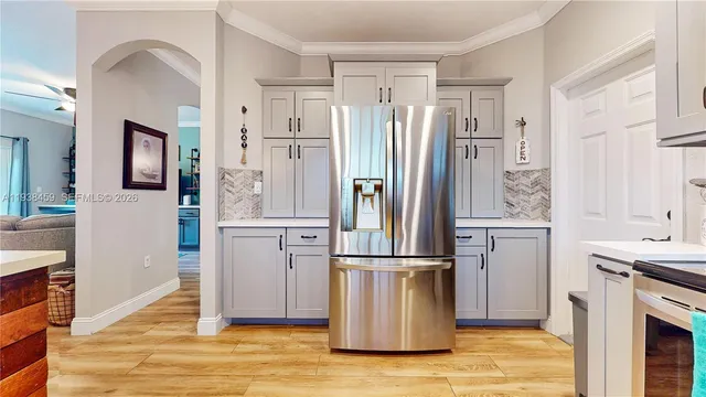 a kitchen with stainless steel appliances a refrigerator sink and cabinets