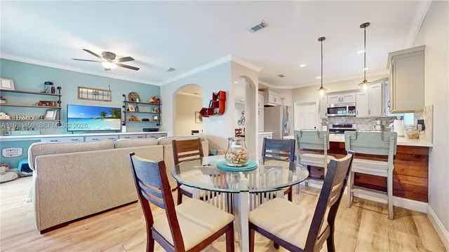 a dining room with furniture and wooden floor