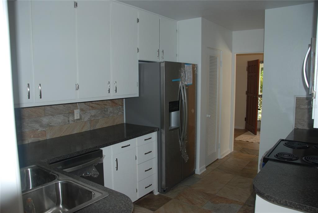 a kitchen with a refrigerator stove and cabinets