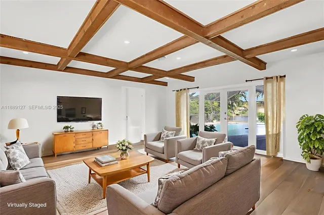 a living room with furniture and a flat screen tv