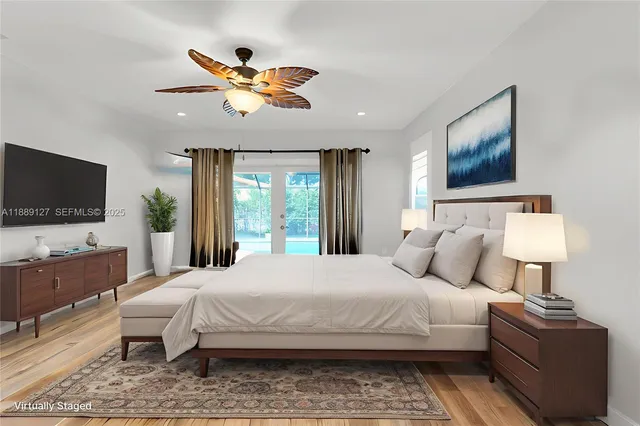 a bedroom with a large bed and a flat screen tv