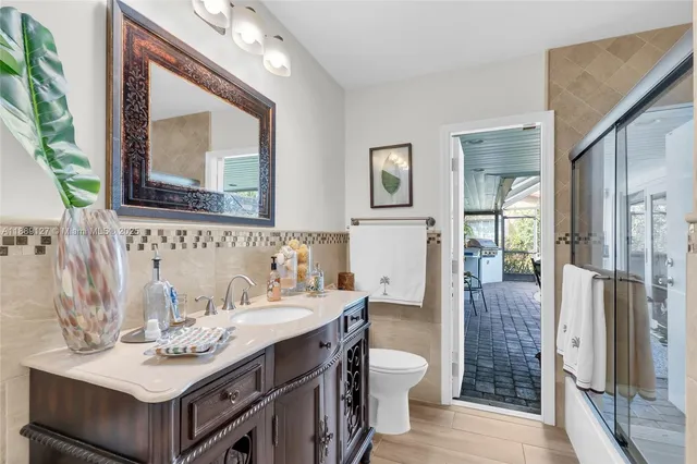 a bathroom with a sink vanity toilet and shower