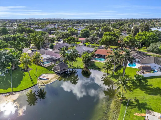 an aerial view of a houses with a yard