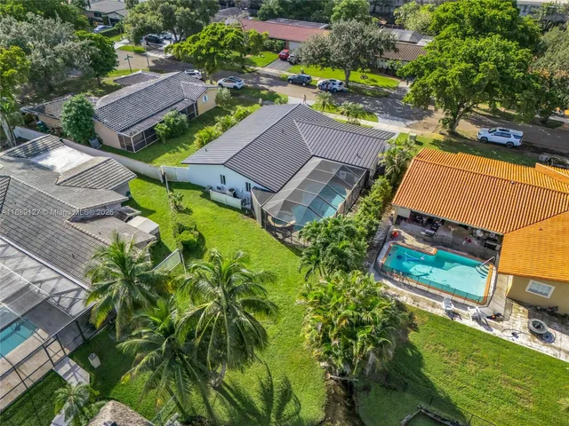 an aerial view of a house with a yard