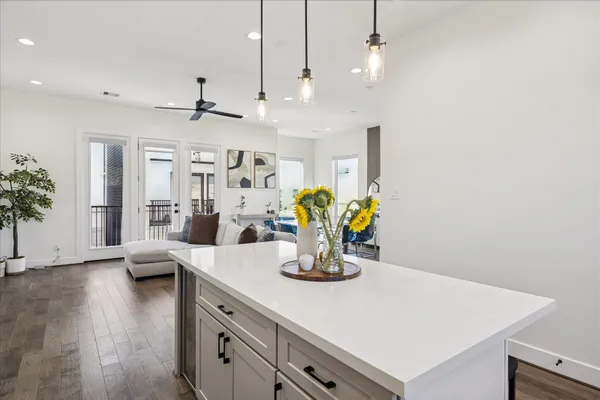 a kitchen with a table a stove and wooden floor