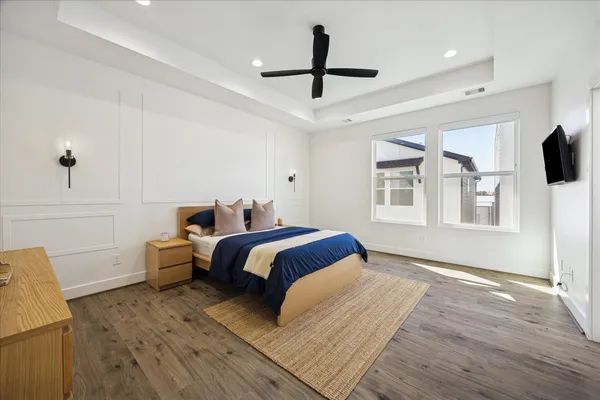 a spacious bedroom with a bed and a window