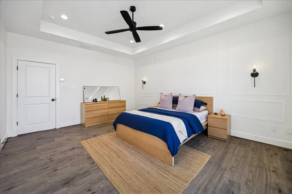 a bedroom with a bed and a ceiling fan