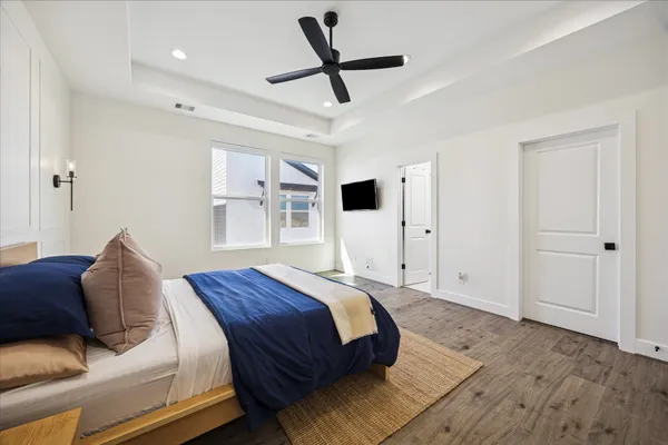 a bedroom with a bed and a ceiling fan