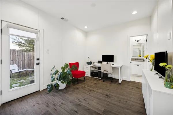 a living room with furniture wooden floor and a flat screen tv