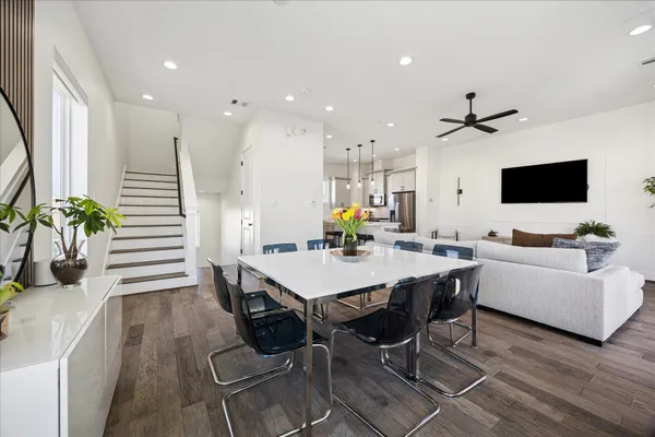 a living room with furniture a flat screen tv and a potted plant