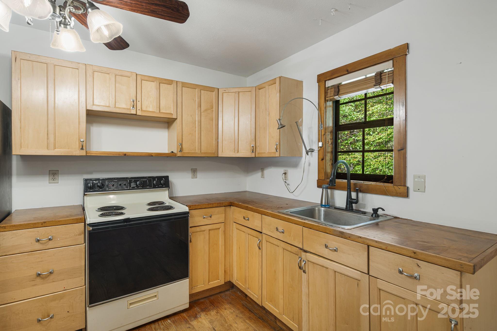 206 Willow Lane Brevard, NC 28712 - Photo 13 of 43 a kitchen with a sink stove and microwave
