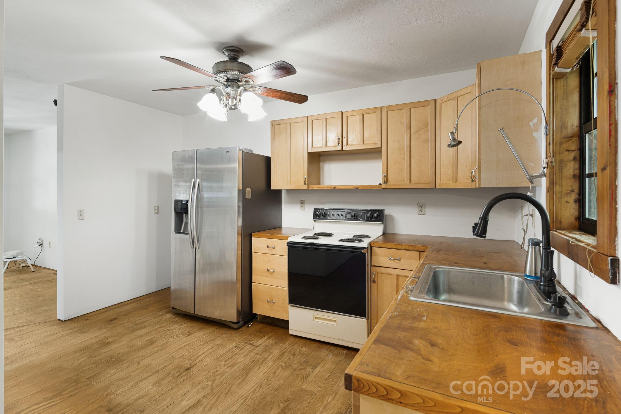 206 Willow Lane Brevard, NC 28712 - Photo 14 of 43 a kitchen with stainless steel appliances granite countertop a sink a stove a refrigerator cabinets and a dining table
