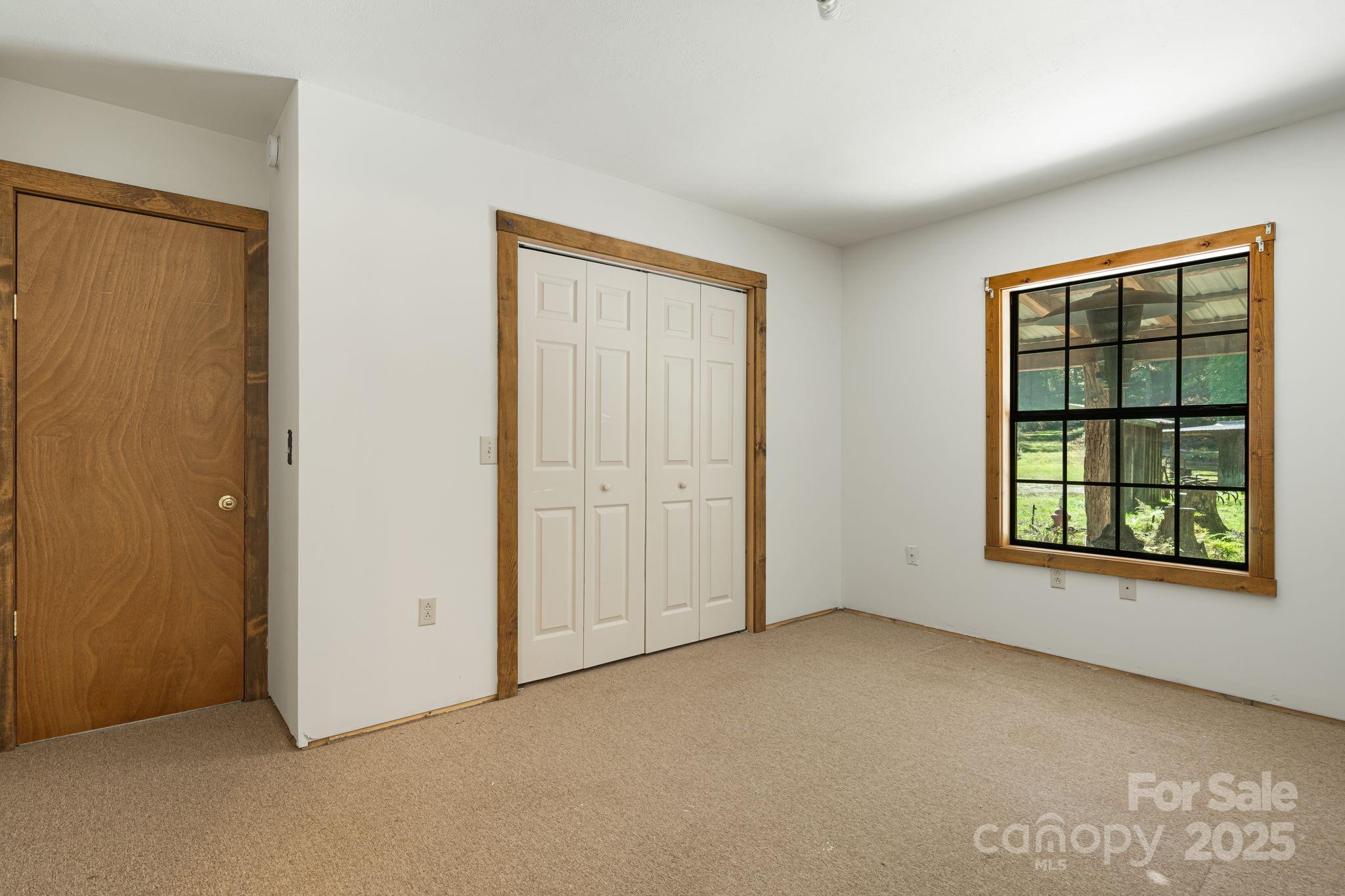 206 Willow Lane Brevard, NC 28712 - Photo 26 of 43 an empty room with windows and closet