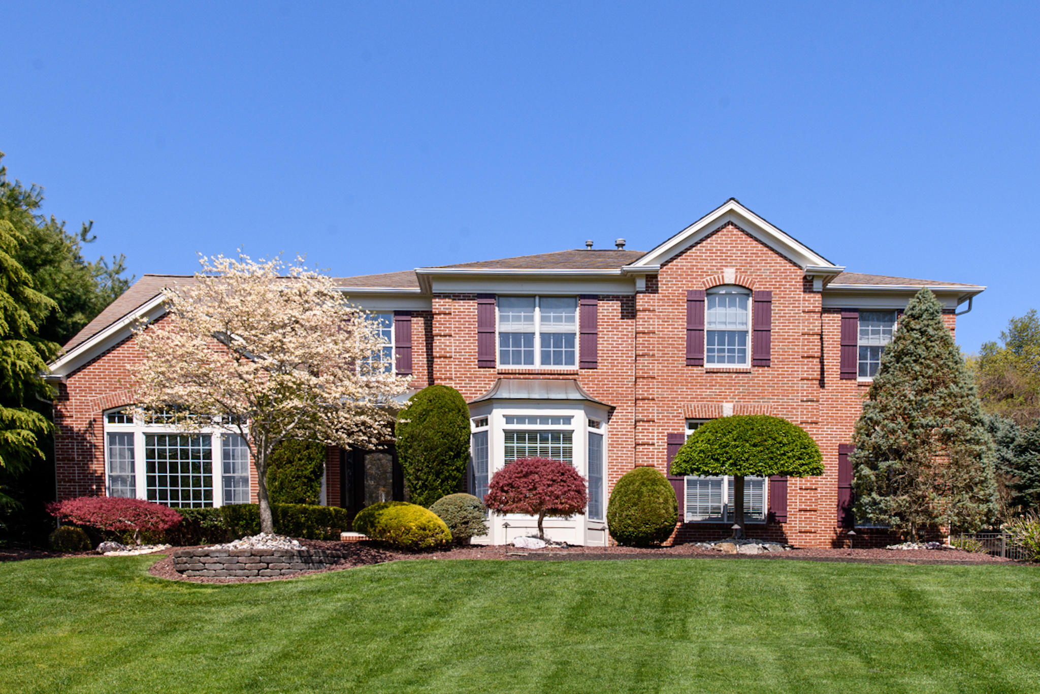 2 Camellia Court Holmdel, NJ 07733 - Photo 1 of 12 a front view of a house with a yard and potted plants