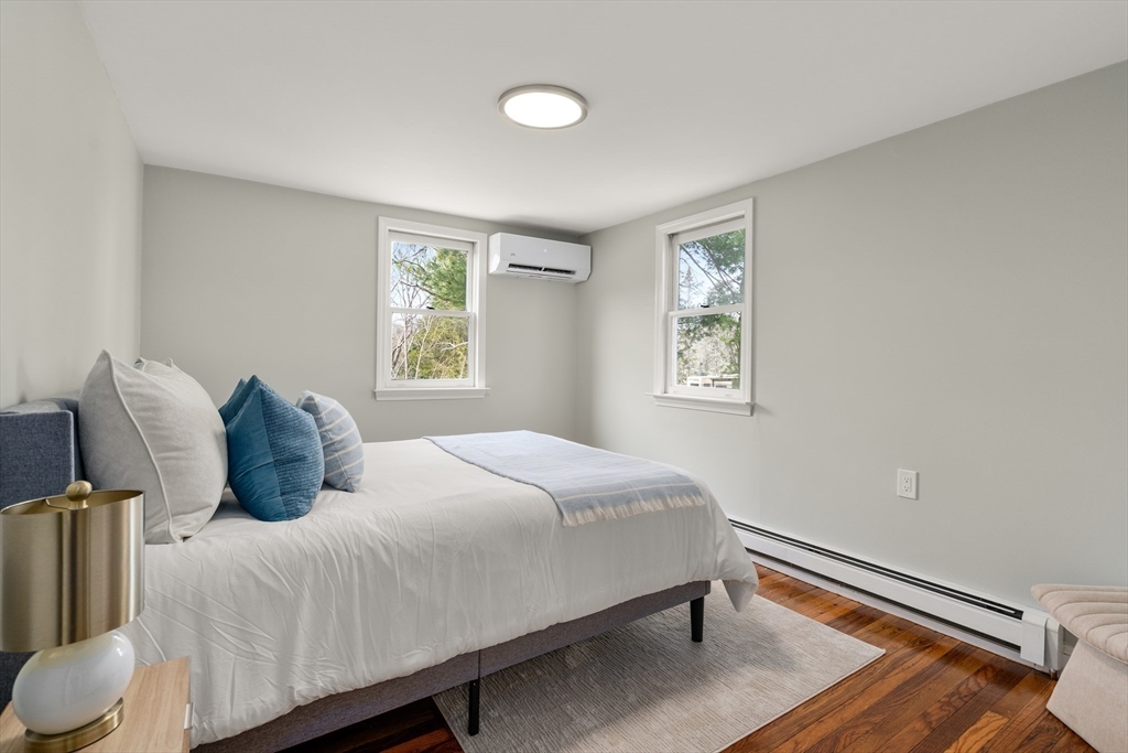 11 Winter Street Foxboro, MA 02035 - Photo 25 of 34 a bedroom with a bed and wooden floor