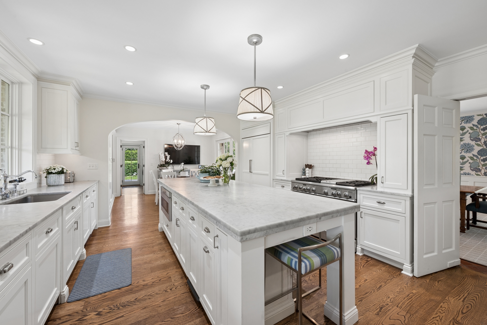 936 Sunset Road Winnetka, IL 60093 - Photo 20 of 50 a large kitchen with kitchen island a stove a sink a center island and cabinets