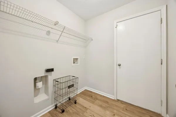 a view of an entryway with wooden floor