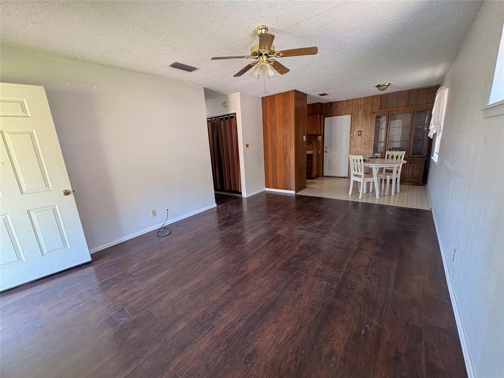 1829 South Center Street Denison, TX 75021 - Photo 8 of 29 a view of a livingroom with wooden floor and a ceiling fan
