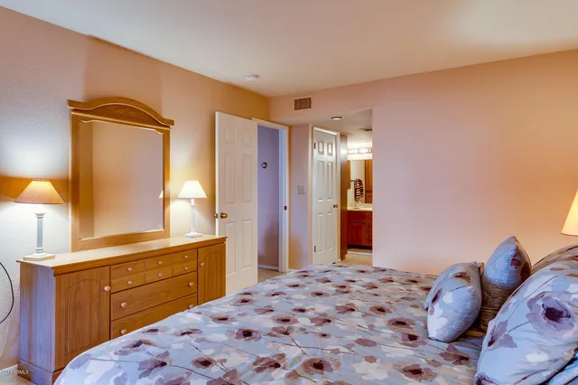 a bedroom with a bed and a dresser in it