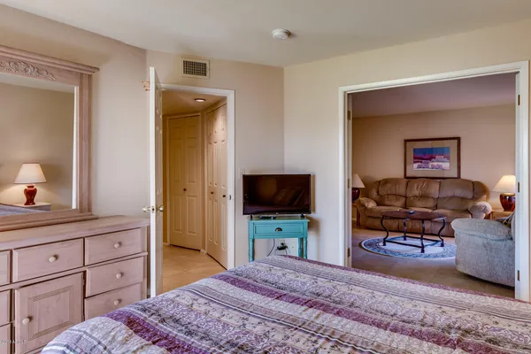 a bedroom with a bed and a flat screen tv