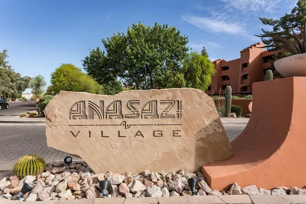 a view of a sign board with trees
