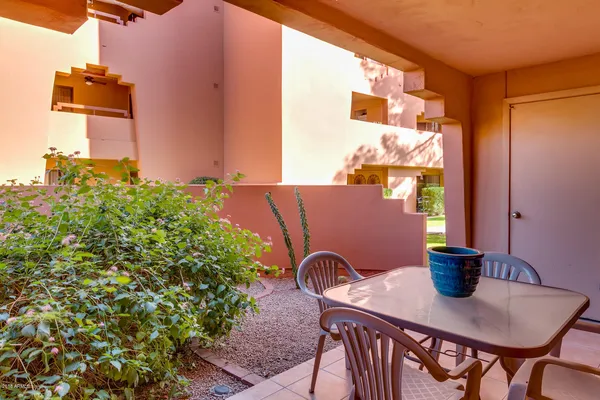 a view of a balcony with table and chairs