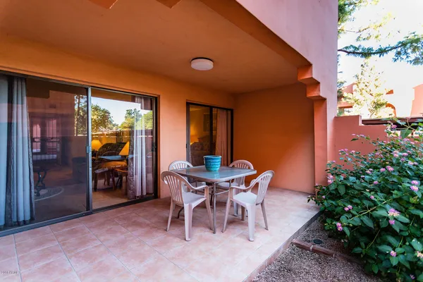 a view of a dining room with furniture and a potted plant