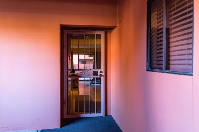 a view of hallway with livingroom and stairs