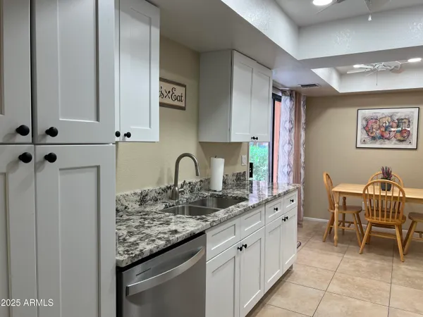 a kitchen with stainless steel appliances granite countertop a sink and cabinets