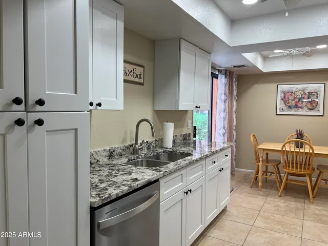 a kitchen with stainless steel appliances granite countertop a sink and cabinets