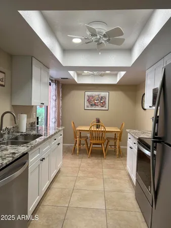 a kitchen with stainless steel appliances granite countertop a sink and cabinets
