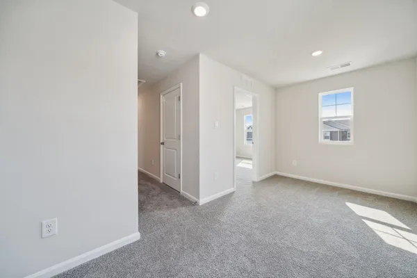 an empty room with a empty space and windows