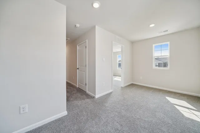 an empty room with a empty space and windows