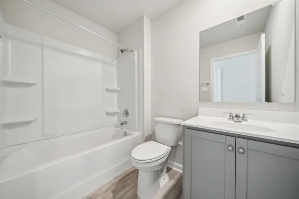 a bathroom with a toilet a sink and bathtub