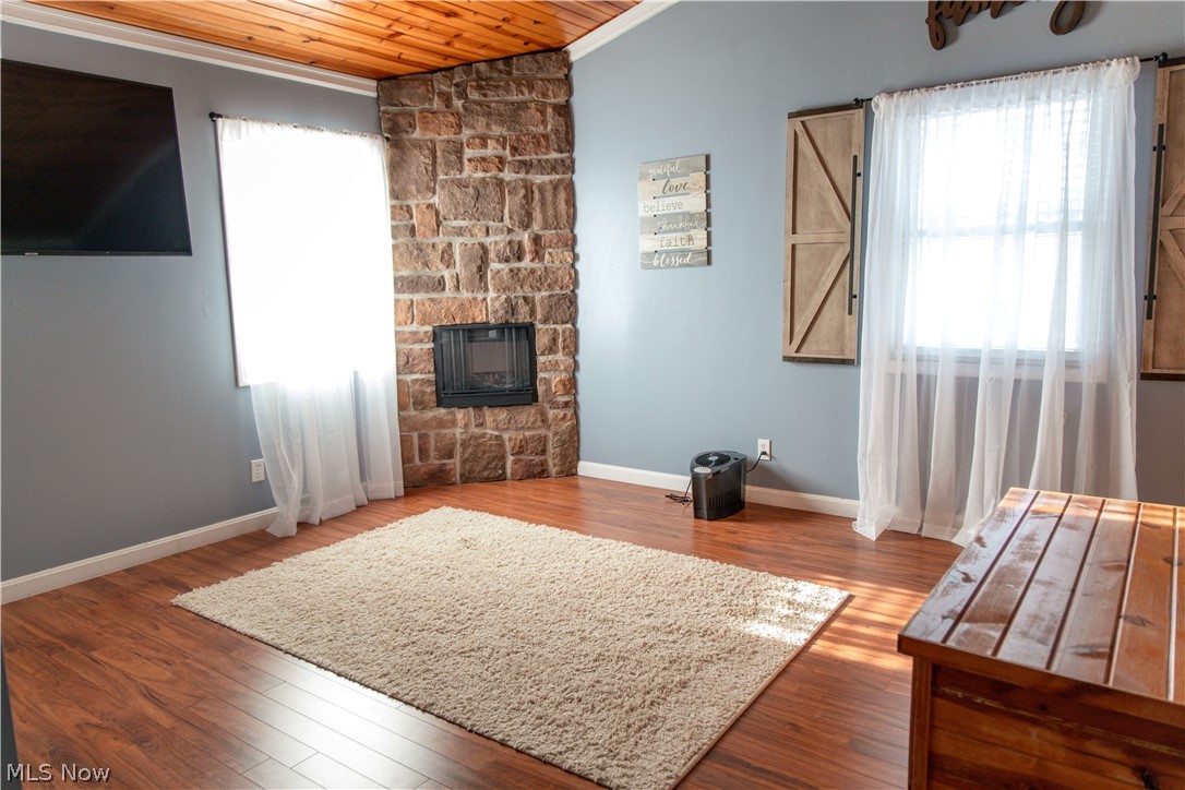 4750 Turney Road Madison, OH 44057 - Photo 27 of 42 Sitting room featuring wood-type flooring, wood ceiling, and a wealth of natural light