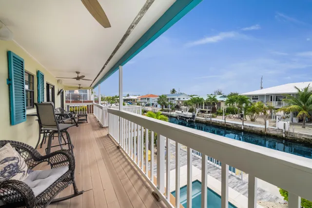 a view of a balcony and car parked