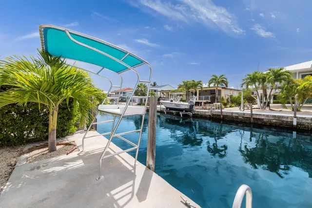 a view of a house with sitting area and swimming pool