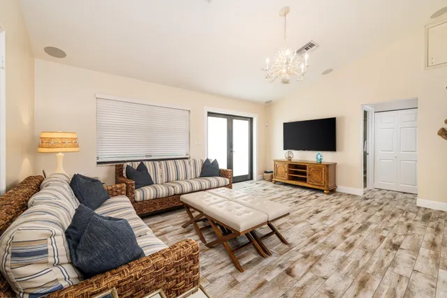 a kitchen with stainless steel appliances granite countertop a refrigerator a stove a sink and a dining table with garden view