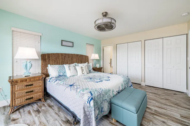 a bedroom with a large bed and a flat screen tv