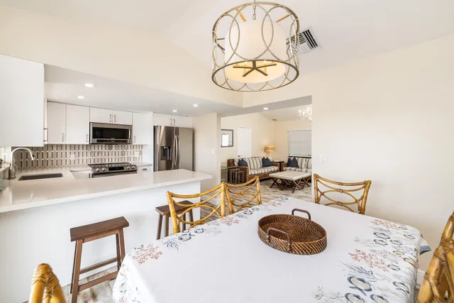 a bedroom with a bed mirror and window