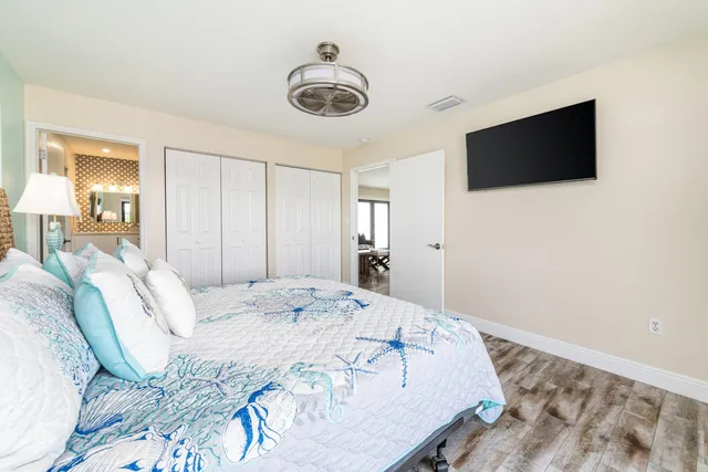 a bedroom with a bed and wooden floor